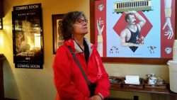 Linda Considering the Movie Choice at Anderson School